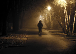 Stranger walking the streets on a cold foggy night. Grain added in postproduction for scarry experience