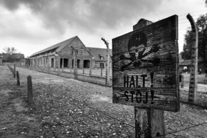 BRZEZINKA, POLAND - OCTOBER 13, 2012: Death warning sign in Auschwitz, concentration camp in Poland. A deadly sign still stands as a reminder of the horrible things that happened inside the camp.
